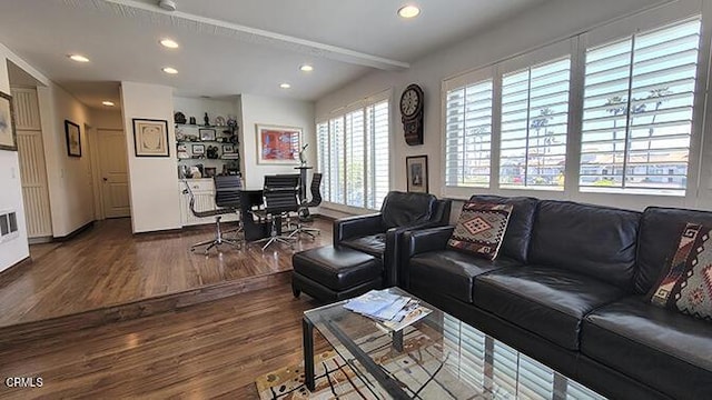 living room featuring beamed ceiling and hardwood / wood-style flooring