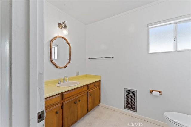 bathroom featuring vanity, toilet, and ornamental molding