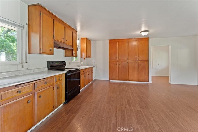 kitchen featuring light hardwood / wood-style floors and black range with electric stovetop