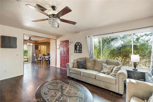 living room with ceiling fan and dark wood-type flooring