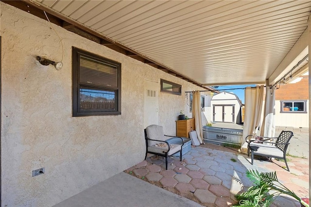 view of patio / terrace featuring a storage unit