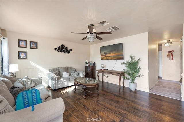 living room featuring dark hardwood / wood-style flooring and ceiling fan