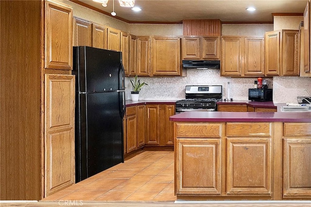 kitchen with black appliances, range hood, and tasteful backsplash