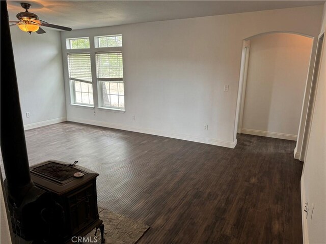 empty room featuring dark hardwood / wood-style flooring and ceiling fan