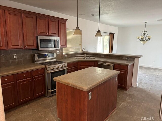 kitchen featuring a kitchen island, appliances with stainless steel finishes, sink, and pendant lighting