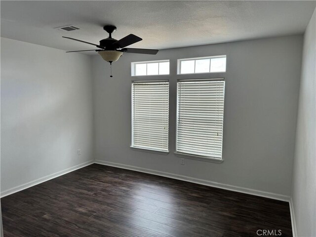 unfurnished room with dark hardwood / wood-style flooring, a textured ceiling, and ceiling fan