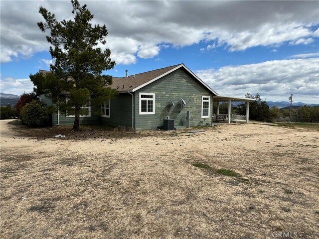 back of property featuring central AC