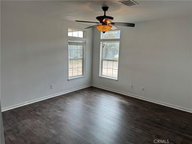 empty room with dark wood-type flooring and ceiling fan