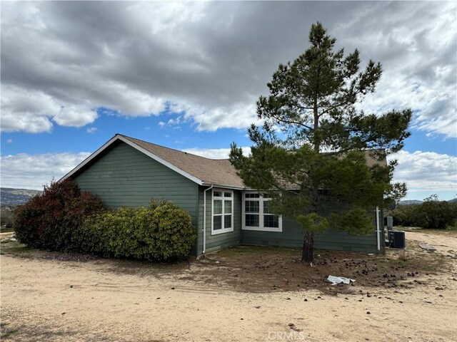 view of side of property with central AC