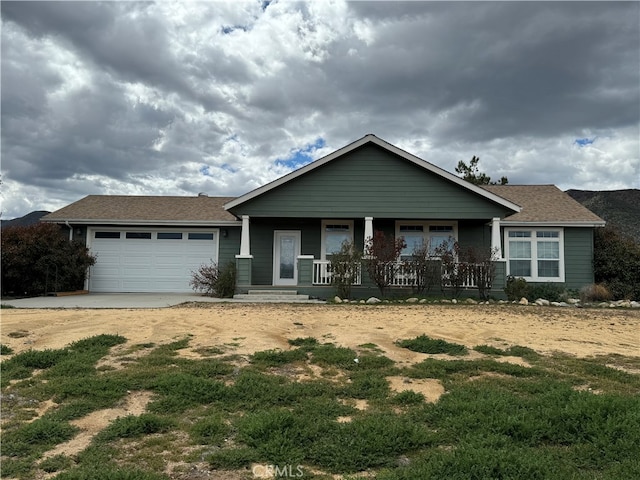 view of front of house featuring covered porch and a garage