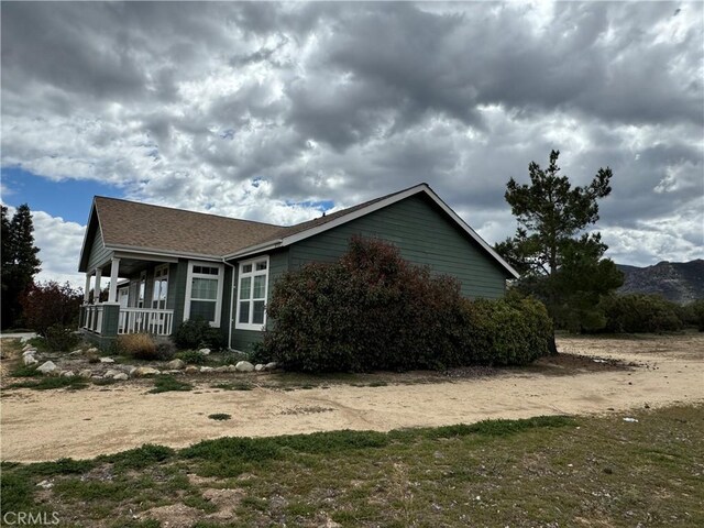 view of property exterior with a porch