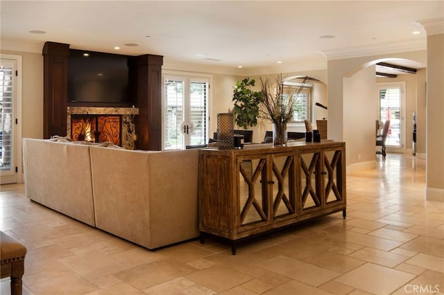 living room featuring a wealth of natural light and crown molding