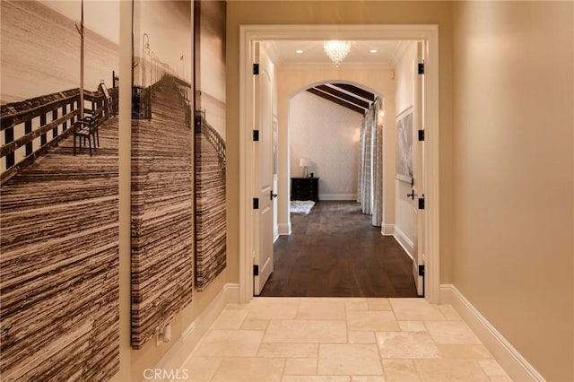 hallway featuring crown molding and light hardwood / wood-style flooring