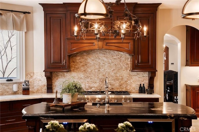 kitchen with tasteful backsplash, wine cooler, and a kitchen island