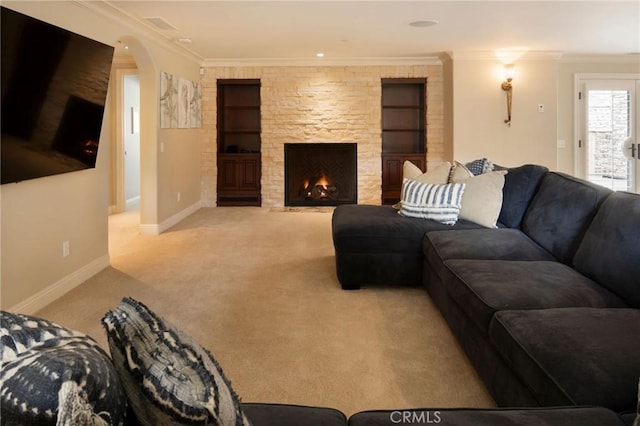 carpeted living room featuring a stone fireplace and crown molding