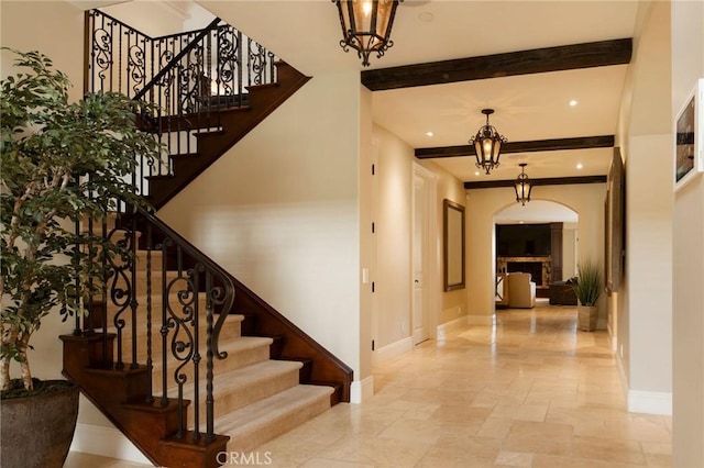 stairs featuring beam ceiling