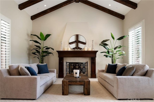 carpeted living room featuring beam ceiling and high vaulted ceiling