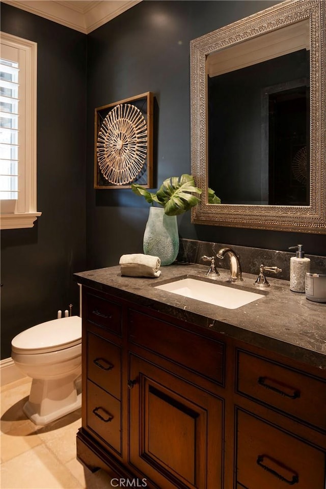 bathroom featuring tile patterned floors, vanity, toilet, and ornamental molding