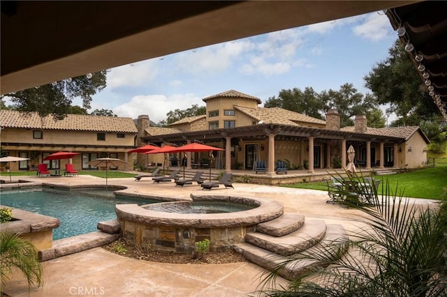 view of pool featuring an in ground hot tub and a patio