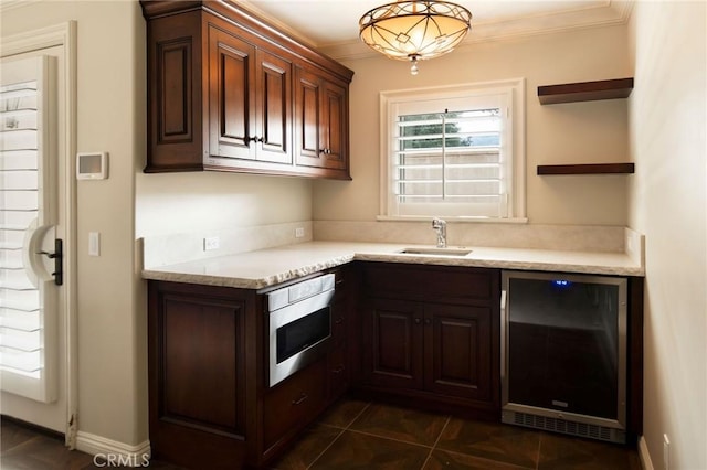 kitchen with wine cooler, crown molding, sink, dark tile patterned flooring, and oven