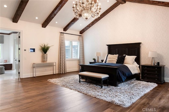 bedroom with dark hardwood / wood-style floors, beam ceiling, and ensuite bath