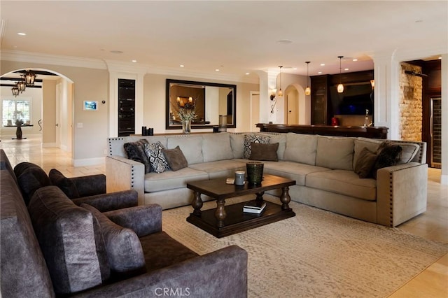 tiled living room with crown molding and an inviting chandelier