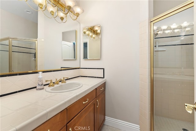 bathroom featuring walk in shower and vanity