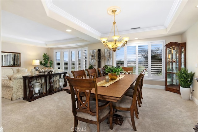 carpeted dining room featuring a tray ceiling, a chandelier, and a wealth of natural light