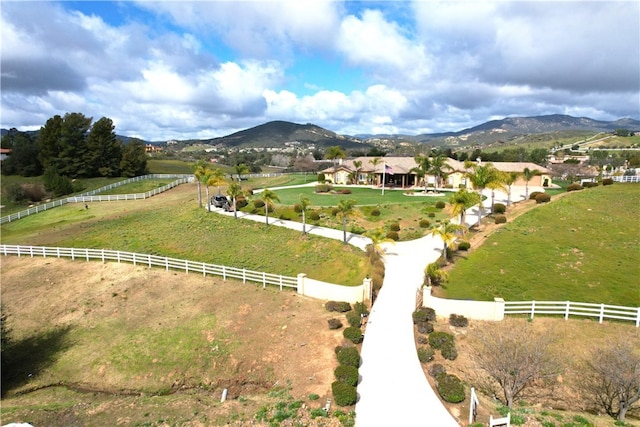 birds eye view of property featuring a mountain view and a rural view