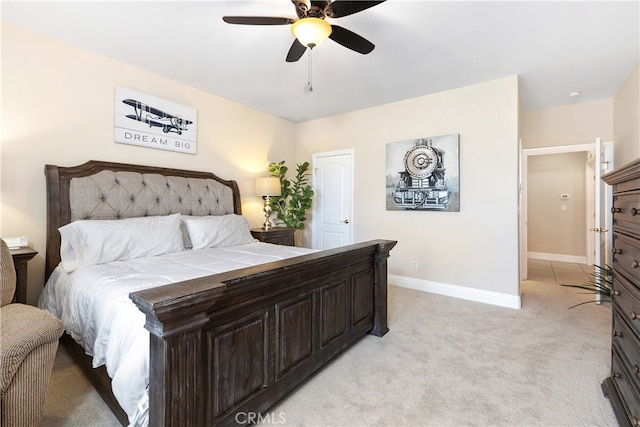 bedroom with ceiling fan and light colored carpet