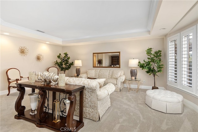 carpeted living room featuring a tray ceiling and ornamental molding