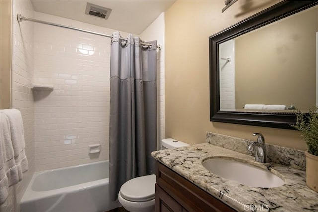 full bathroom with toilet, vanity, and shower / tub combo with curtain