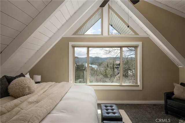 carpeted bedroom with a mountain view and lofted ceiling with beams