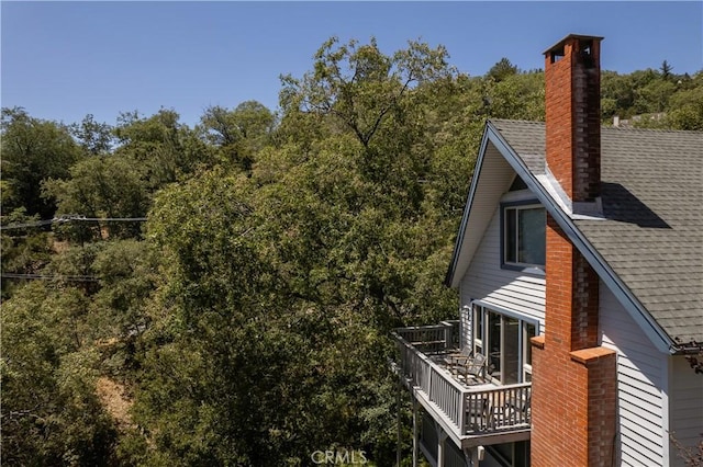 view of home's exterior with a balcony