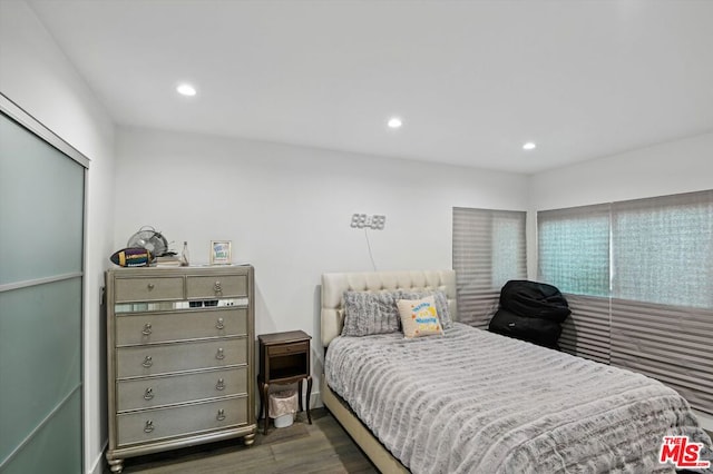 bedroom with dark hardwood / wood-style floors