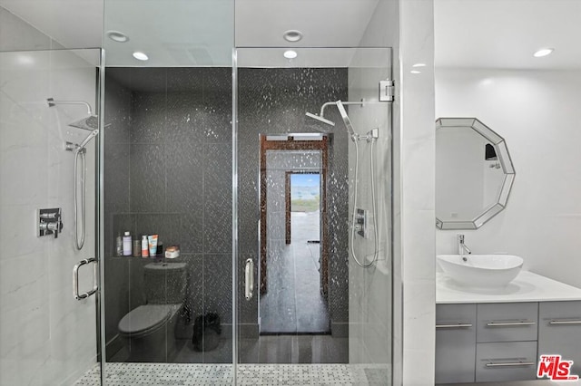 bathroom featuring oversized vanity and a shower with shower door