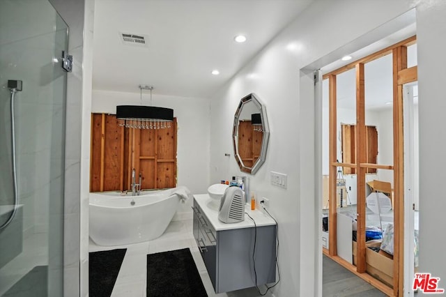 bathroom with tile floors and separate shower and tub