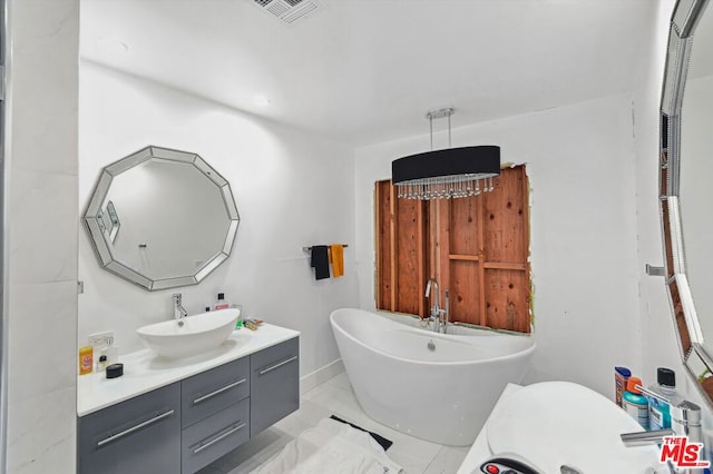 bathroom with tile flooring and vanity