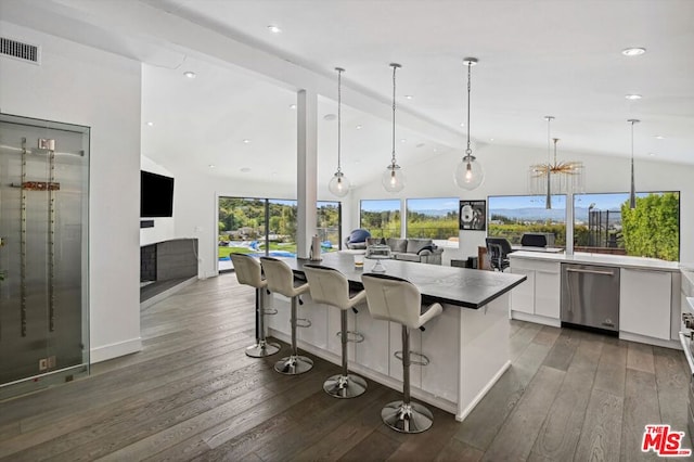 kitchen with hardwood / wood-style floors, a breakfast bar, beam ceiling, dishwasher, and white cabinets