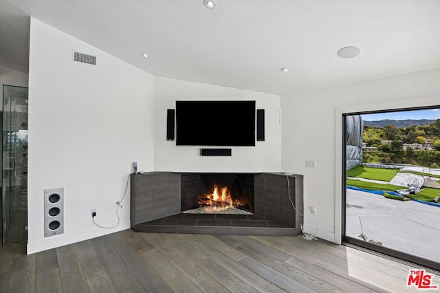 unfurnished living room with dark wood-type flooring and vaulted ceiling