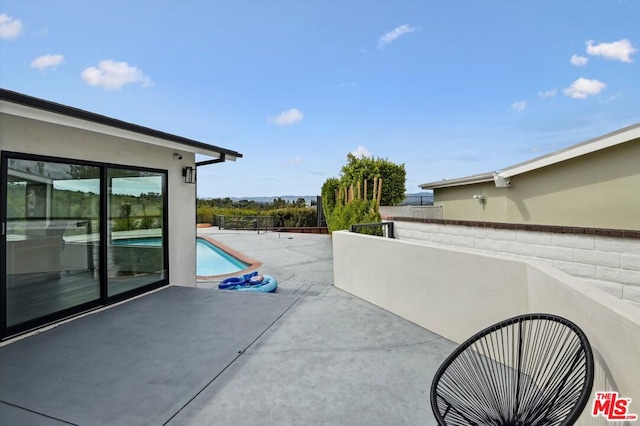 view of patio / terrace featuring a fenced in pool