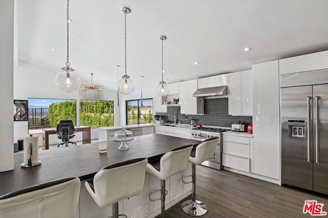 kitchen featuring tasteful backsplash, stainless steel built in refrigerator, stove, white cabinetry, and dark hardwood / wood-style floors