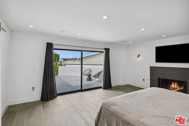 bedroom featuring access to outside and light hardwood / wood-style flooring