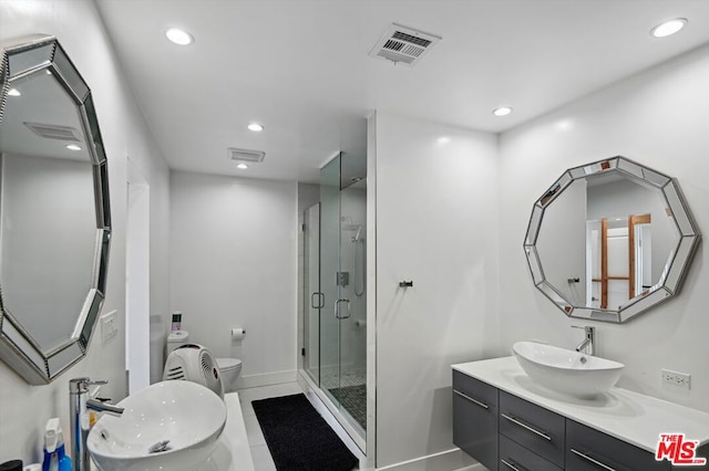 bathroom with tile flooring, a shower with door, toilet, and oversized vanity