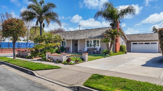 ranch-style house featuring a front lawn and a garage