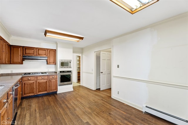 kitchen featuring appliances with stainless steel finishes, baseboard heating, and dark hardwood / wood-style floors