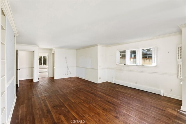 unfurnished living room featuring dark wood-type flooring, a baseboard heating unit, and plenty of natural light