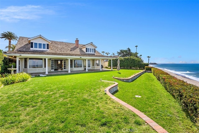 view of front facade with a front yard and a water view