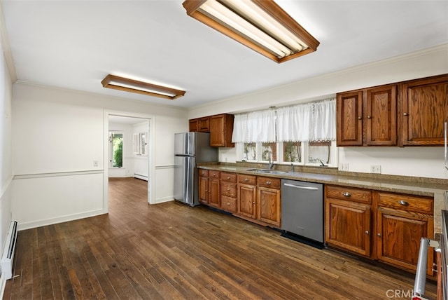 kitchen featuring a healthy amount of sunlight, stainless steel appliances, sink, and dark hardwood / wood-style flooring