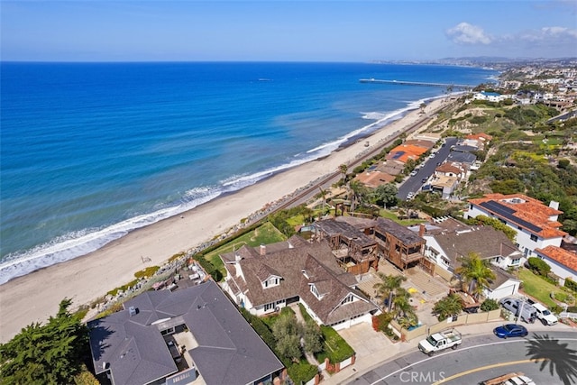 bird's eye view featuring a view of the beach and a water view